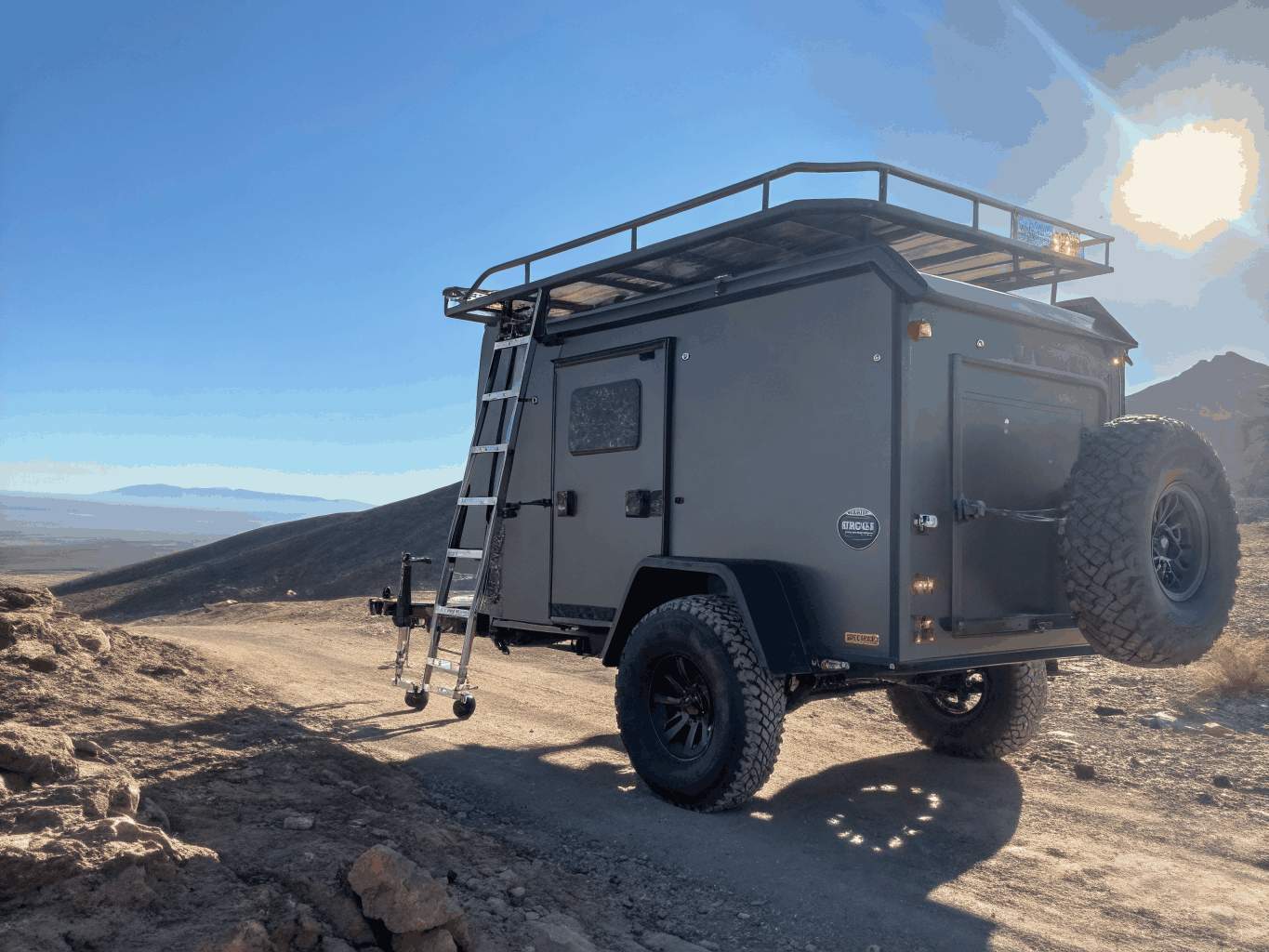 Rooftop expedition tent mounted on vehicle at mountain overlook